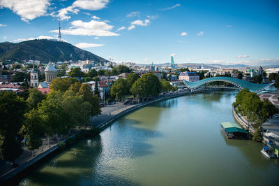 The bridge of peace over kura river by mountains against sky