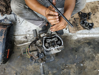 Low section of man repairing equipment