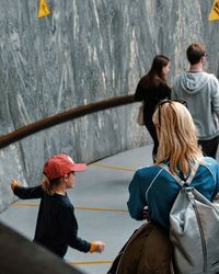 Rear view of people standing on road