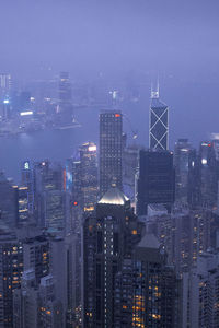 Illuminated cityscape against sky at night