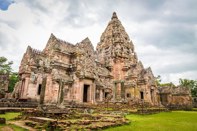 Old temple building against cloudy sky