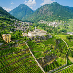 High angle view of agricultural field and buildings against sky