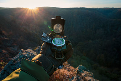 Man standing on rocks against mountains