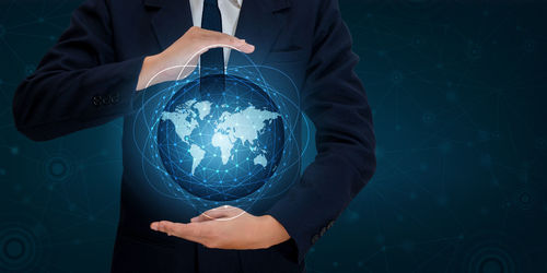 Digital composite image of businessman with globe