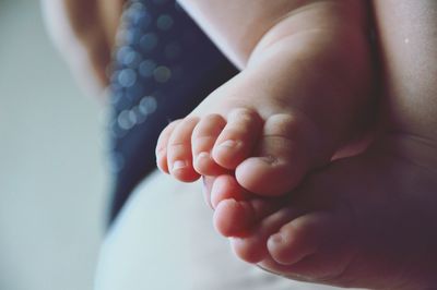 Close-up of baby feet on hand