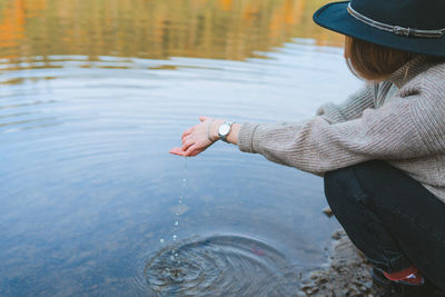 Midsection of woman in lake