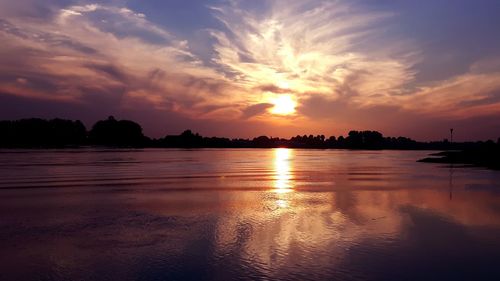 Scenic view of dramatic sky over landscape during sunset