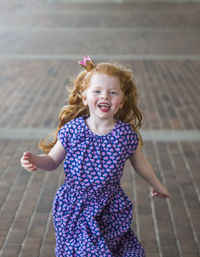 Close-up of girl running on road