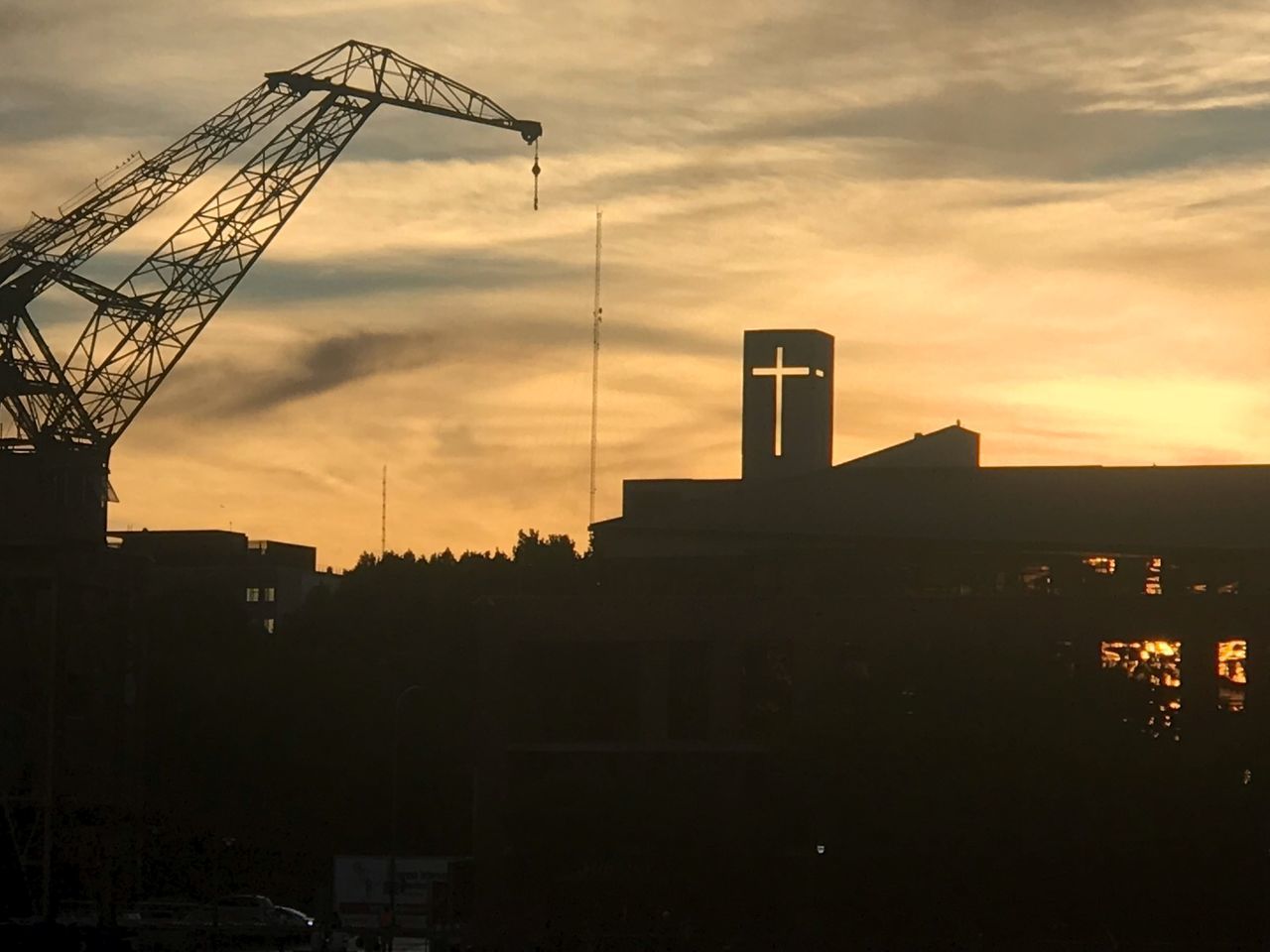 SILHOUETTE CRANES AGAINST SKY AT SUNSET