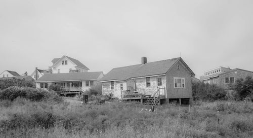 Abandoned house on field against sky