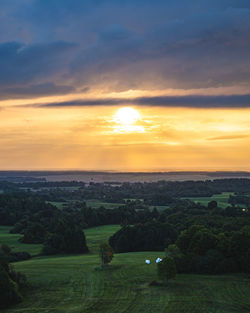 Scenic view of field against sky during sunset