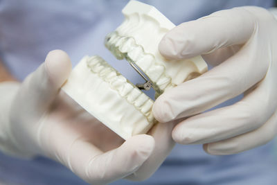 Close-up of hand holding white fabric