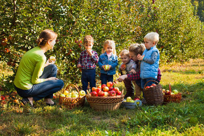 People standing by fruits in basket