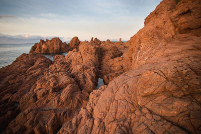 Rock formations in sea against sky