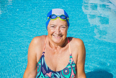 Portrait of a smiling young woman swimming pool