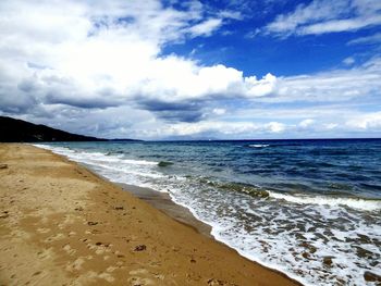 Scenic view of sea against cloudy sky