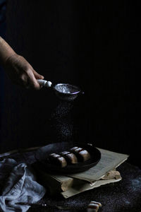 Cropped hand of man preparing food