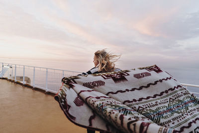 Woman looking at sea against sky