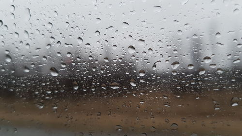 Full frame shot of raindrops on window