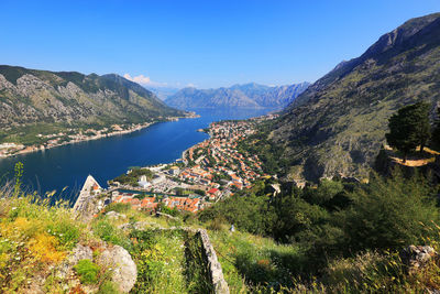 High angle view of kotor town by sea amidst mountains