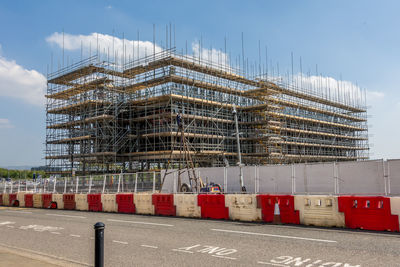 Construction site against sky in city