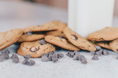 Close-up of cookies by milk glass