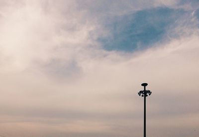 Low angle view of telephone pole against sky