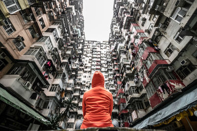 Rear view of man and buildings in city