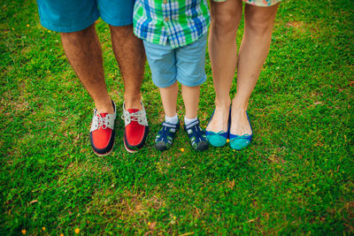 Low section of people standing on grassland