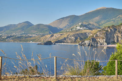 Scenic view of lake against clear blue sky