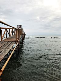 Pier over sea against sky