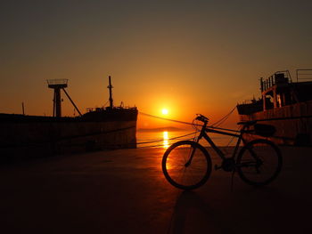 Low angle view of silhouette bicycle against sky during sunset