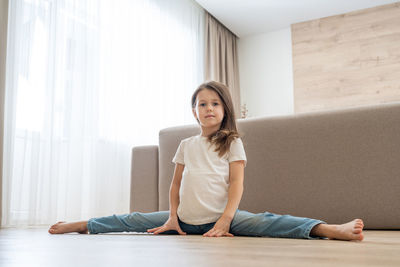 Portrait of smiling woman sitting on floor at home