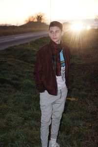 Portrait of young man standing in field