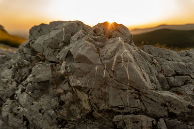 Close-up of rock against sky during sunset