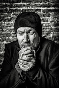 Portrait of man standing against wall