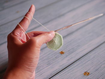 Close-up of hand holding seashell