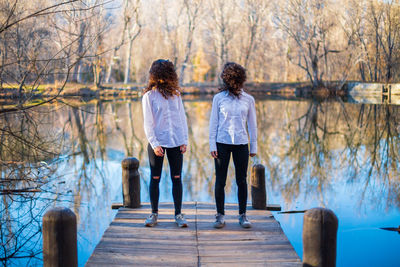 Rear view of couple standing against trees