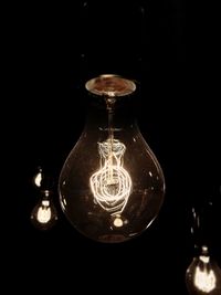 Close-up of illuminated lamp against black background