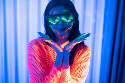 Close-up of illuminated light painting against blue wall