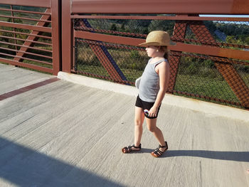 Cute girl walking on footbridge 