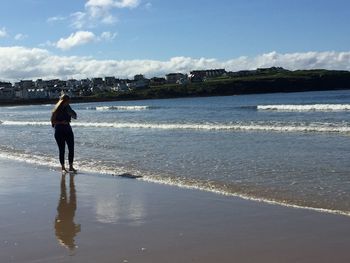 Rear view of man walking on beach