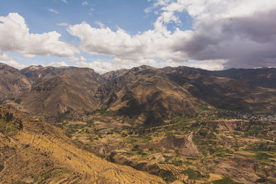 Scenic view of mountains against cloudy sky