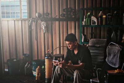 Man looking at camera while sitting on table