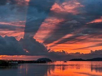 Scenic view of sea against romantic sky at sunset