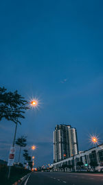 Low angle view of illuminated buildings against sky at night