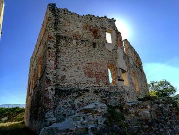 Low angle view of old ruin building against sky