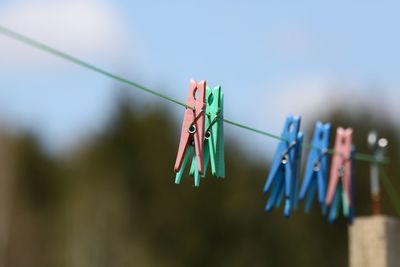 Close-up of clothespins hanging on clothesline