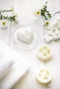 High angle view of white roses in vase on table