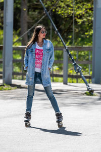 Full length of young woman standing in park